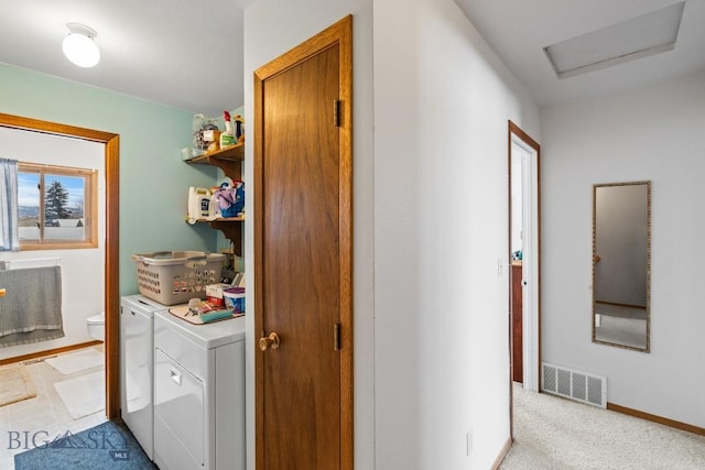 laundry room with washing machine and dryer and light colored carpet