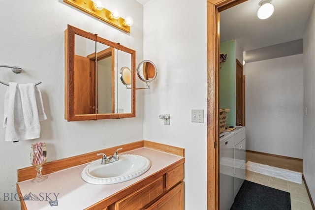 bathroom with vanity and washer and clothes dryer