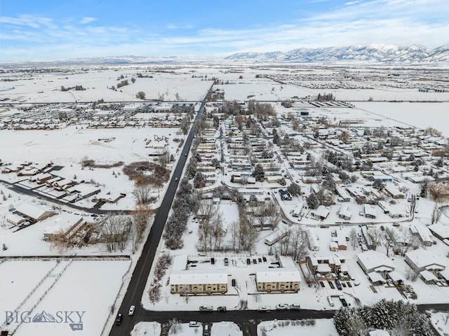 snowy aerial view featuring a mountain view