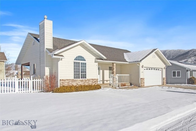 ranch-style home featuring a garage and covered porch