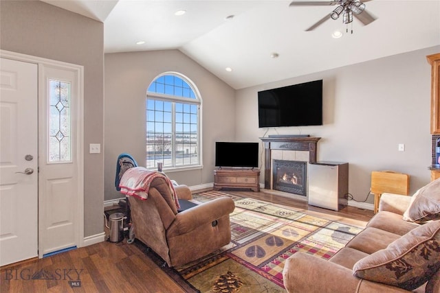 129 Red Mtn, Butte, MT 59701 - living area featuring vaulted ceiling, wood finished floors, ceiling fan, baseboards, and a tile fireplace