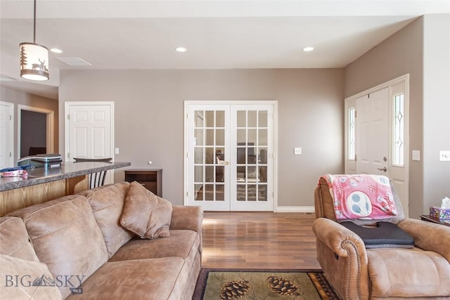 living room featuring wood-type flooring and french doors