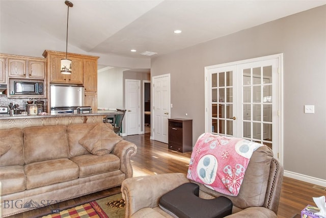 living room featuring lofted ceiling, french doors, and dark hardwood / wood-style floors