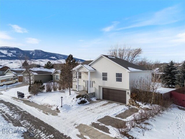 view of front of home with a mountain view and a garage