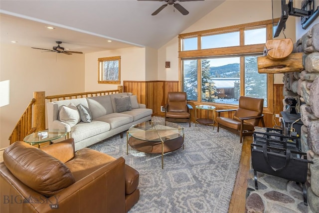 living room with ceiling fan, vaulted ceiling, and wood-type flooring