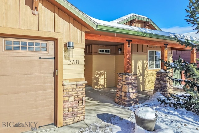 view of snow covered property entrance