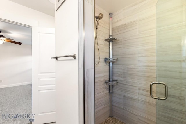 bathroom featuring ceiling fan and an enclosed shower