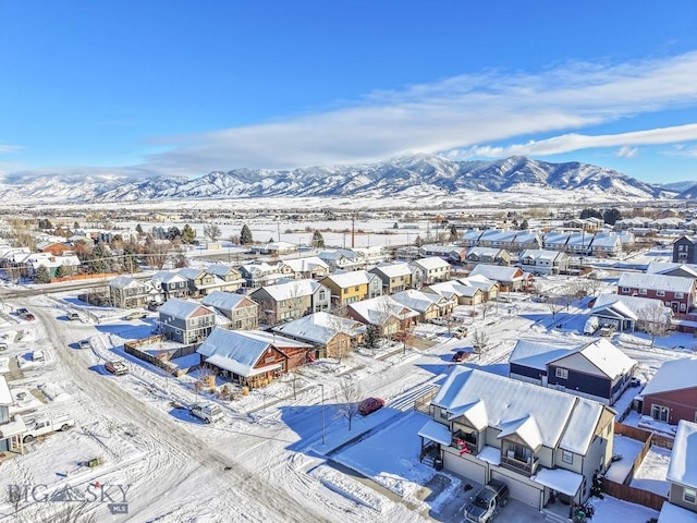 snowy aerial view featuring a mountain view