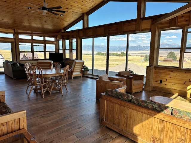 interior space with a healthy amount of sunlight, wooden ceiling, vaulted ceiling, and a mountain view