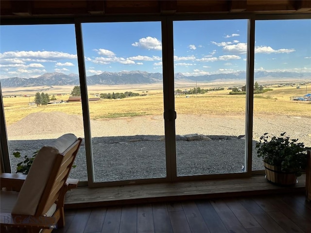 sunroom / solarium featuring a rural view and a mountain view