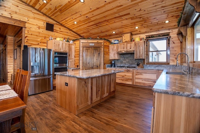 kitchen featuring stainless steel appliances, sink, a center island, dark hardwood / wood-style flooring, and wood ceiling