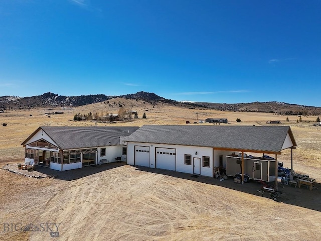 view of front of property featuring a garage and a mountain view