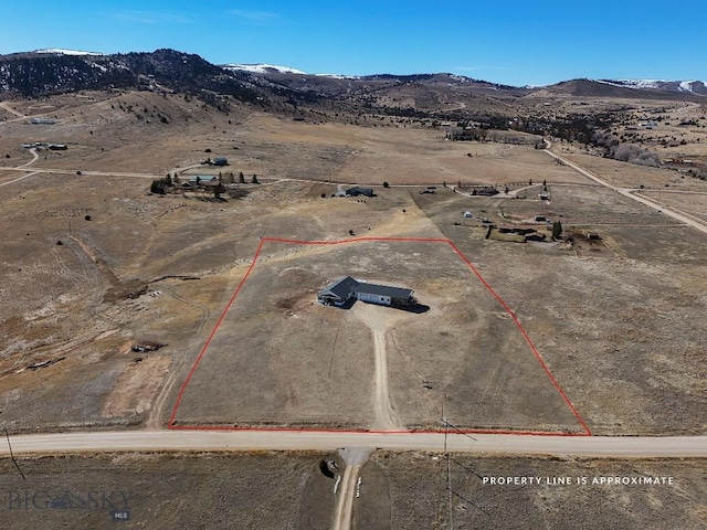 birds eye view of property with a mountain view