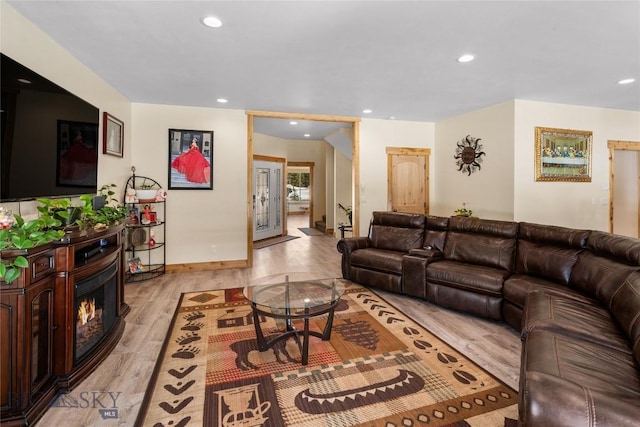 living room with light wood-type flooring and french doors