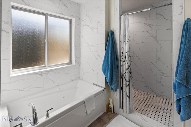 bathroom featuring hardwood / wood-style flooring and separate shower and tub