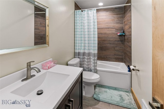 full bathroom with shower / tub combo with curtain, vanity, and toilet