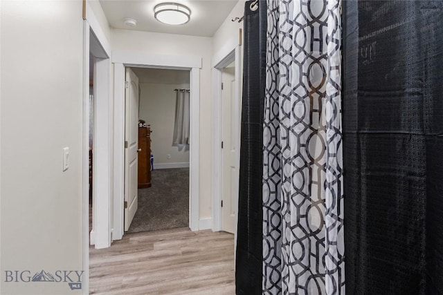 hallway with light hardwood / wood-style flooring