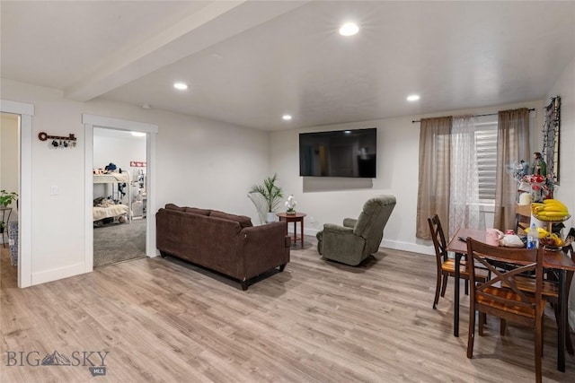 living room with beam ceiling and light hardwood / wood-style flooring