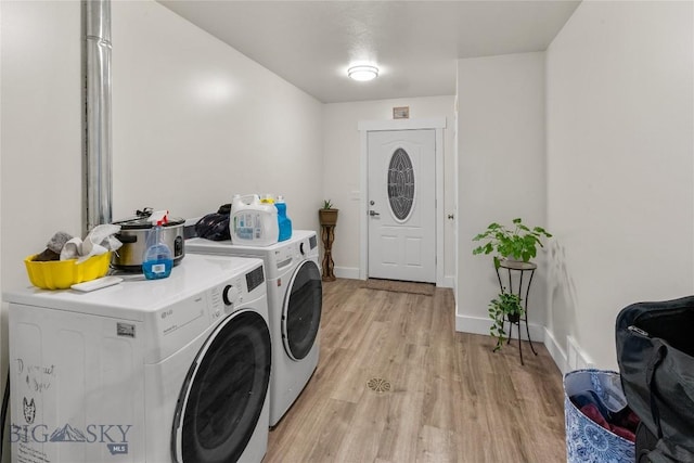 washroom featuring washer and dryer and light wood-type flooring