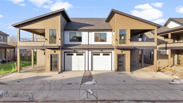 back of house with a balcony and a garage