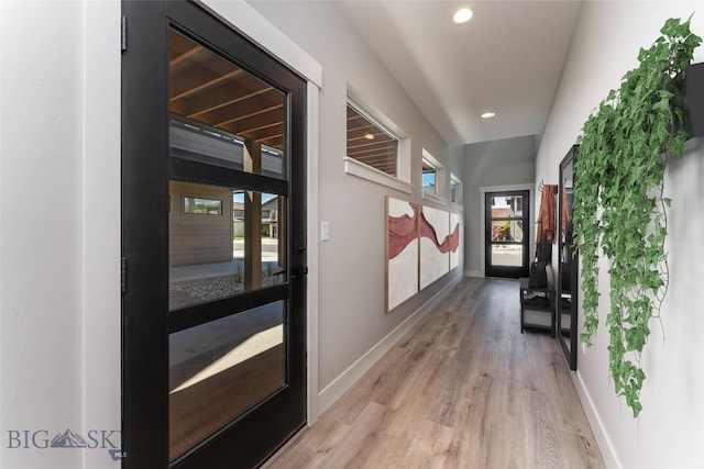 hallway with light wood-type flooring and french doors