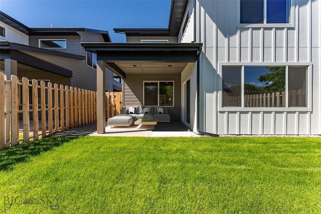 rear view of house featuring a patio and a yard