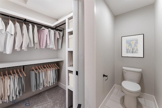 bathroom with toilet and tile patterned flooring