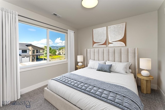 carpeted bedroom with multiple windows