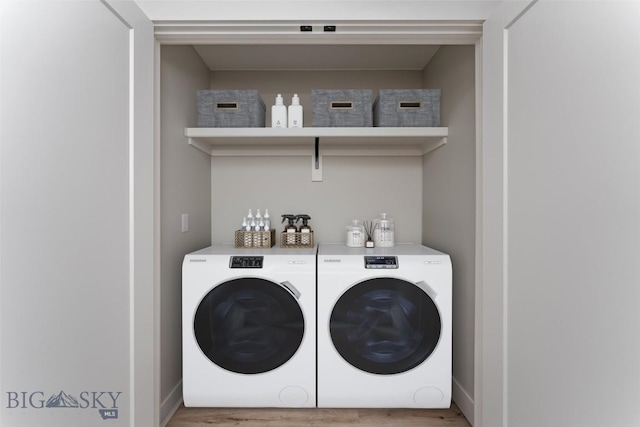 washroom featuring hardwood / wood-style floors and washing machine and clothes dryer