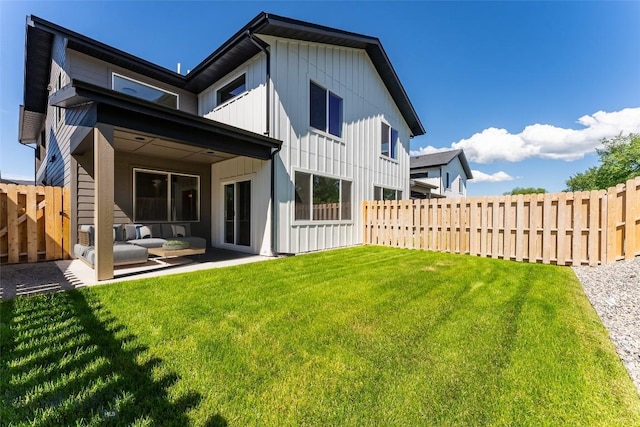 back of house featuring an outdoor hangout area, a patio, ceiling fan, and a yard