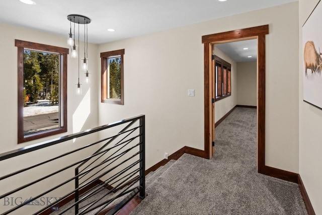 corridor featuring dark colored carpet