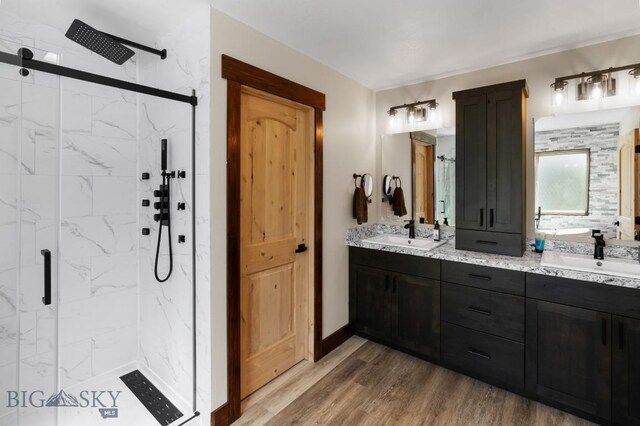 bathroom featuring an enclosed shower, vanity, and hardwood / wood-style floors