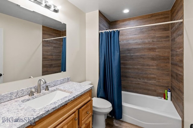 full bathroom featuring toilet, shower / bathtub combination with curtain, and vanity