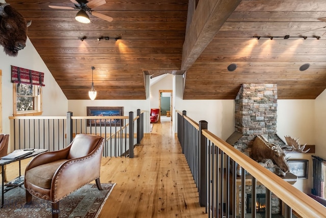 hallway featuring an upstairs landing, wood ceiling, hardwood / wood-style floors, and vaulted ceiling