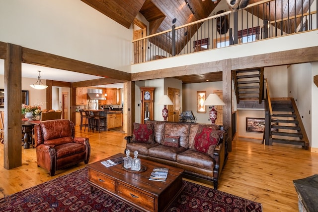 living area with wooden ceiling, stairway, and wood finished floors