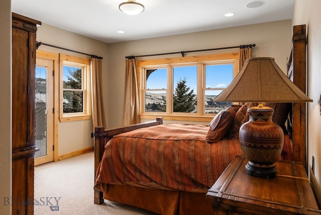 bedroom with recessed lighting, baseboards, multiple windows, and light colored carpet