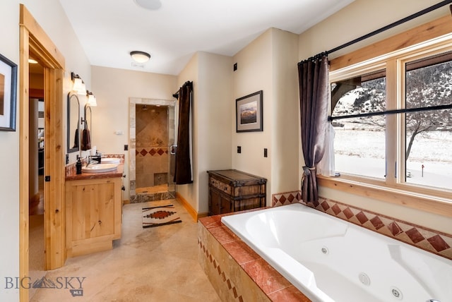 full bath featuring vanity, a stall shower, and a whirlpool tub