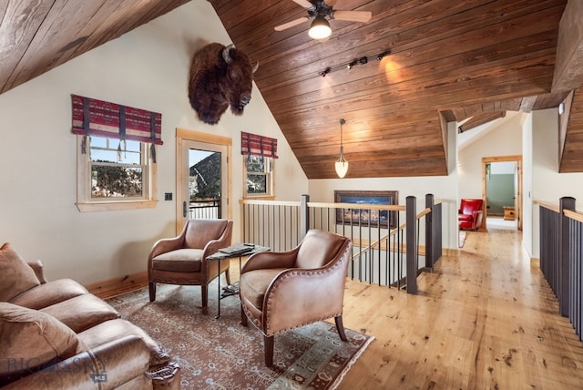 living area with an upstairs landing, vaulted ceiling, wood ceiling, and hardwood / wood-style floors