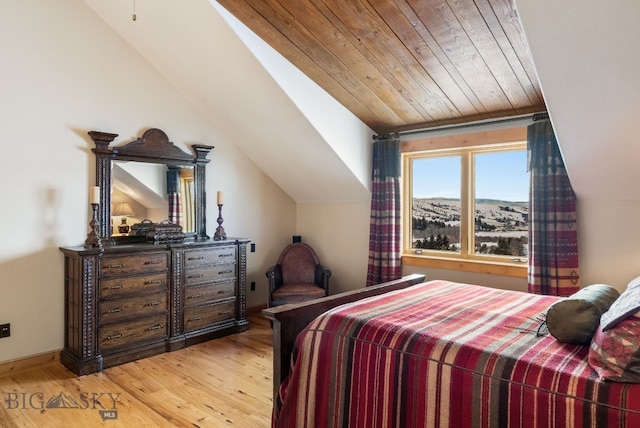 bedroom featuring lofted ceiling, light wood-type flooring, and wooden ceiling