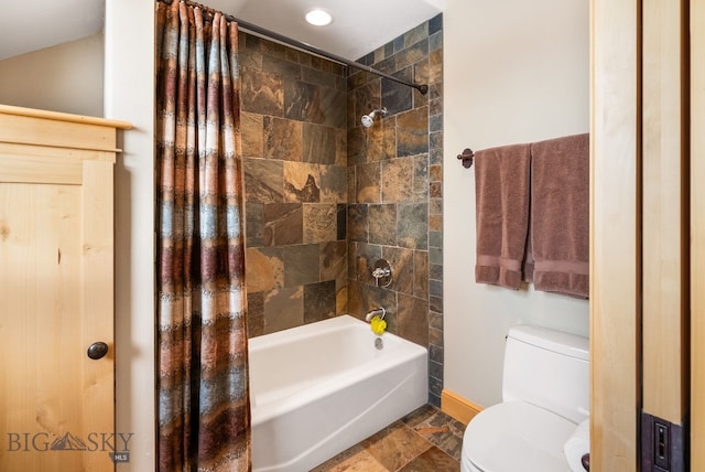 bathroom featuring toilet, baseboards, shower / bath combo with shower curtain, and stone finish flooring