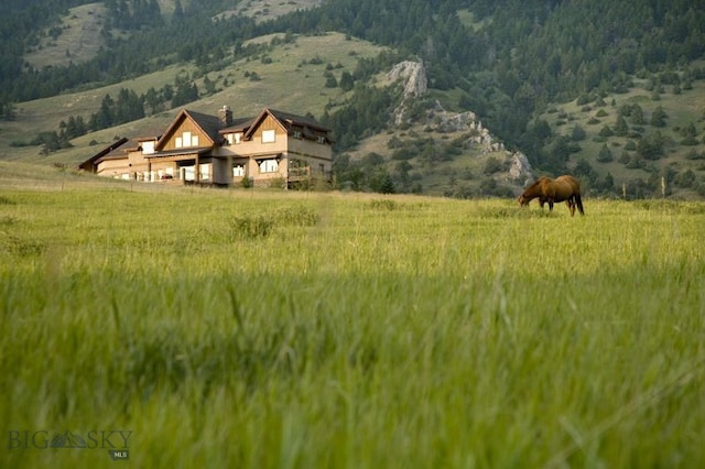 property view of mountains featuring a rural view and a wooded view