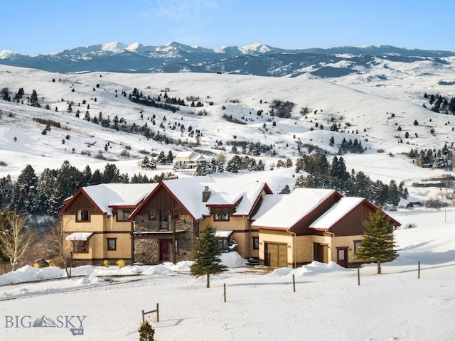 snowy aerial view featuring a mountain view