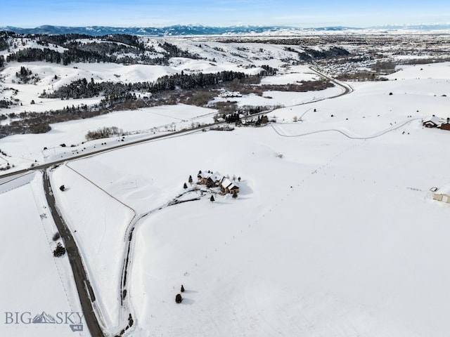 snowy aerial view with a mountain view