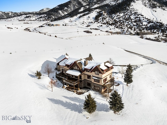 snowy aerial view featuring a mountain view