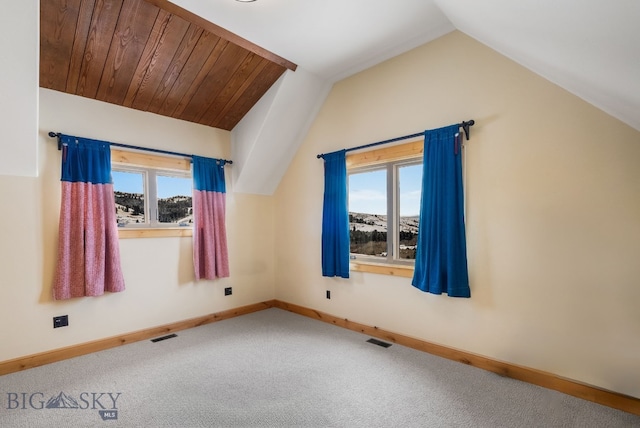 bonus room featuring lofted ceiling, carpet flooring, baseboards, and visible vents