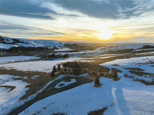 snowy aerial view featuring a mountain view