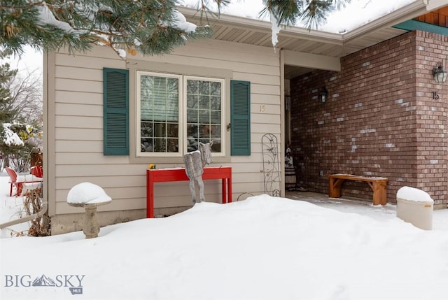 view of snow covered property entrance