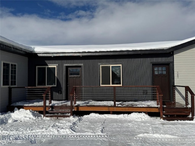 view of snow covered property entrance