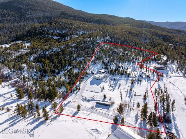 snowy aerial view with a mountain view