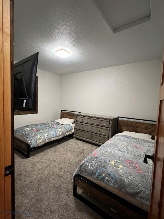 carpeted bedroom featuring a textured ceiling